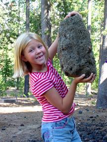 Summer showing how strong she is, with large pumice rock